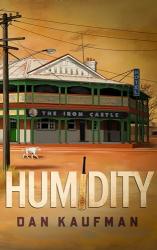 The image of the book cover for Humidity by Dan Kaufman has a drawing of a town pub, The Iron Castle. It&#039;s a two story wooden building with a verandah and balcony. There&#039;s a Hotel sign on the side, and it&#039;s a combination of green posts, white and tan coloured walls. There&#039;s an electricity line running in front, a TV aerial on the roof, and a white dog walking down a red dirt road. The I in the title of the book is a cricket bat.