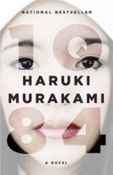 The book cover for IQ 84 by Haruki Murakami has the taglines &#039;National Bestseller&#039; and &#039;A Novel&#039;. The image is of the face of a woman, up very close with a wash of shading over the top, the title of the book is spread across the image, in relief so that parts of her image are more clearly visible.